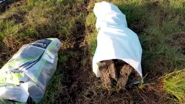 Donegal, Ireland - August 11 2021 : Bags filled with peat fuel lying on the peat bog — Stock Video