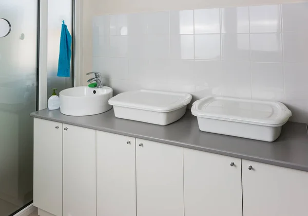 Sink and enameled containers for washing and disinfection in the clinic room for processing reusable medical equipment and instruments