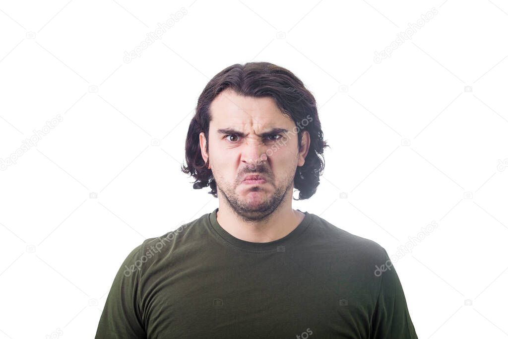 Bewildered and confused young man looking perplexed and upset to camera isolated on white background. Angry casual guy, long curly hair style, irritated face, negative emotions.