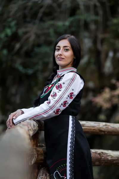 Mujer con traje bulgaro en el bosque — Foto de Stock