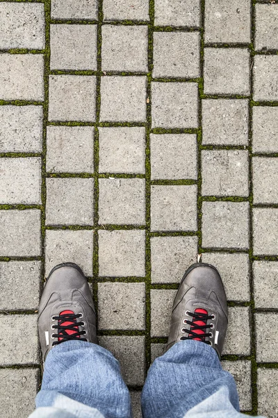 Feet of a man on the pavement — Stock Photo, Image