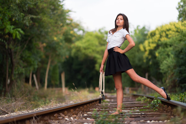 Girl posing on the railway line