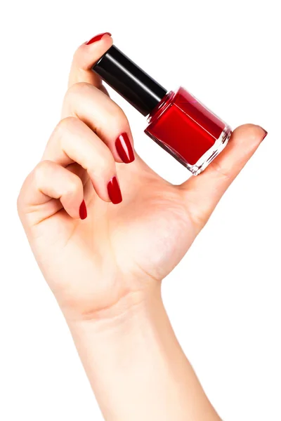 Vernis à ongles rouge dans une main — Photo