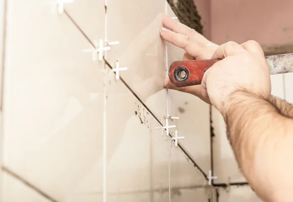 Worker tiler puts ceramic tiles — Stock Photo, Image