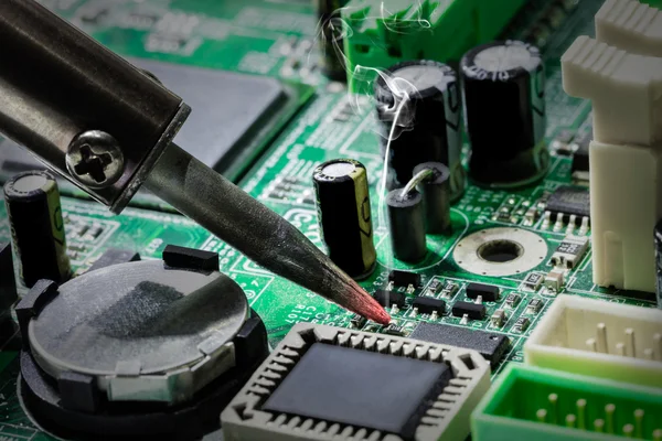 Smoking soldering iron — Stock Photo, Image