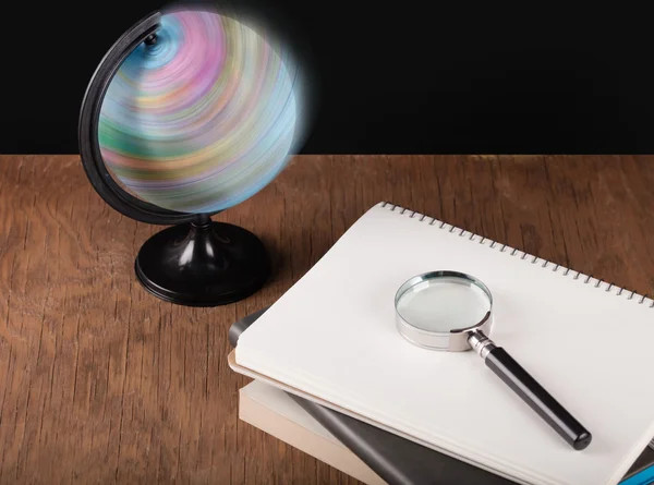 Spinning globe and notebooks — Stock Photo, Image