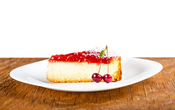 Cheesecake on a white plate with cherries — Stock Photo, Image