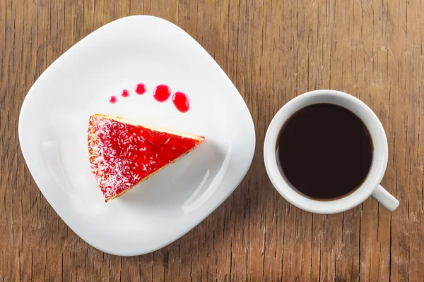 A piece of cake and a cup of black coffee — Stock Photo, Image