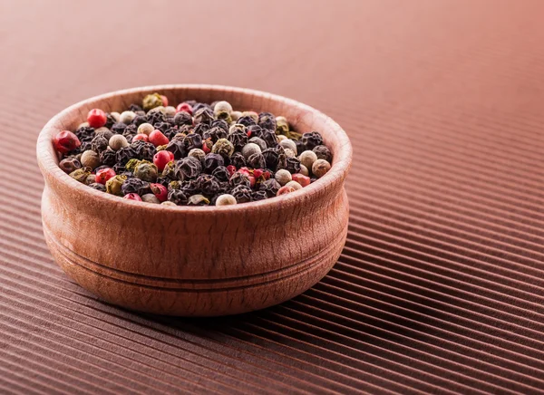 Spice pepper in a wooden bowl — Stock Photo, Image
