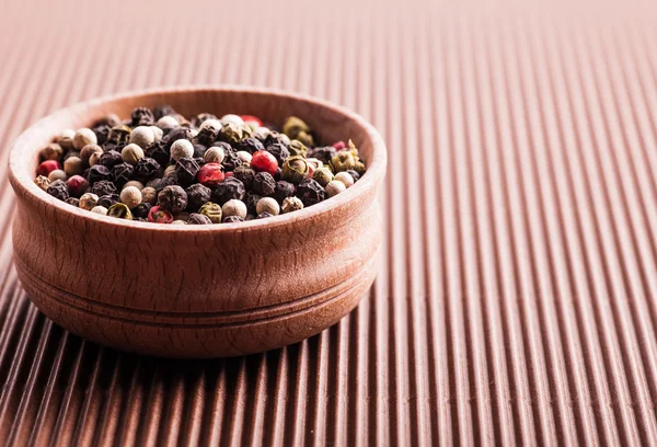 Assorted pepper in a wooden bowl — Stock Photo, Image