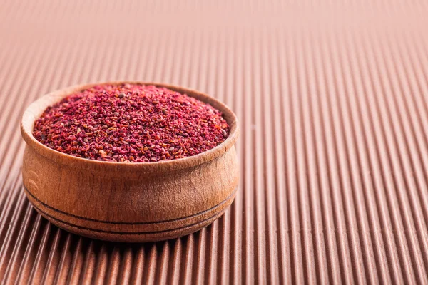 Spice sumac in a wooden bowl — Stock Photo, Image
