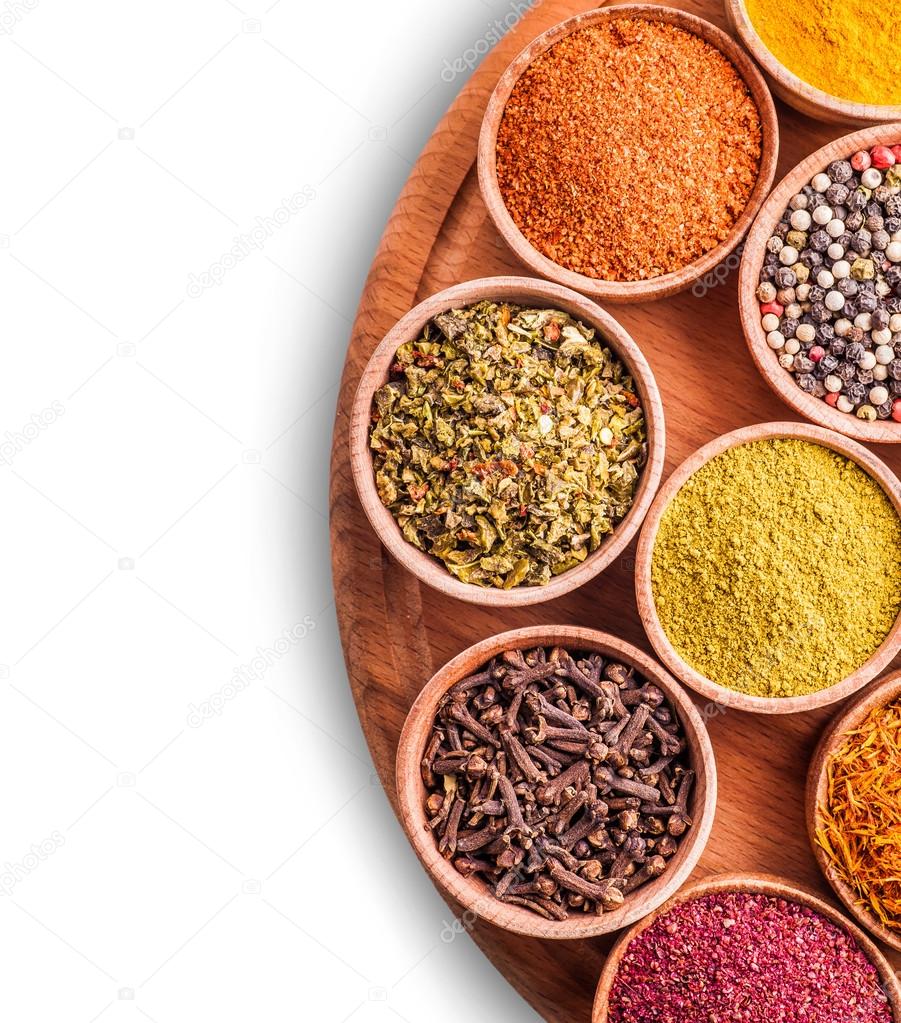 assorted spices in a wooden bowl 