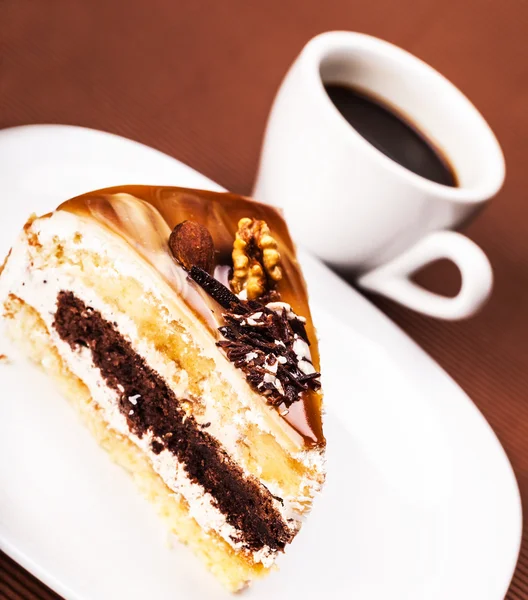 Piece of walnut cake and a coffee — Stock Photo, Image