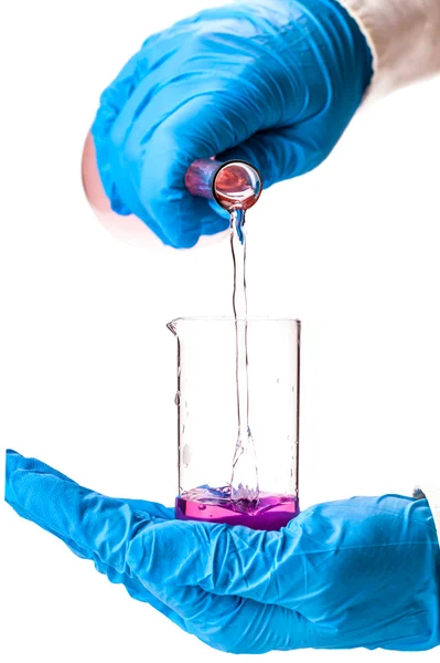 Assistant reagent pouring into the flask — Stock Photo, Image