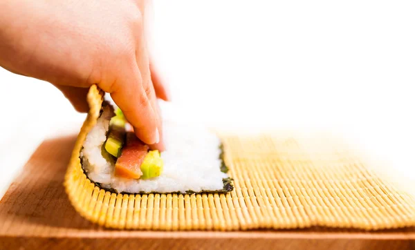 Chef turns nori sheet with filling — Stock Photo, Image