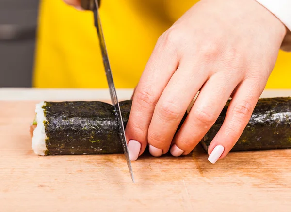 Chef cuts the roll closeup — Stock Photo, Image