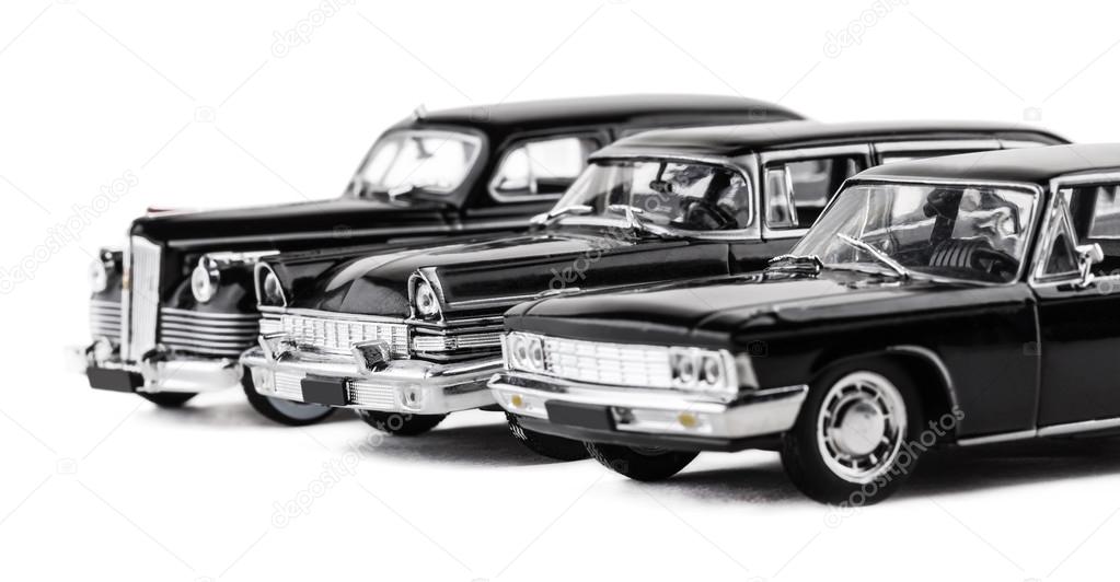 three retro toy cars