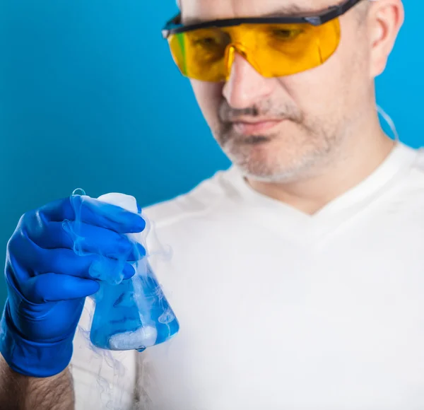 Muž chemik zkoumá zkumavky — Stock fotografie