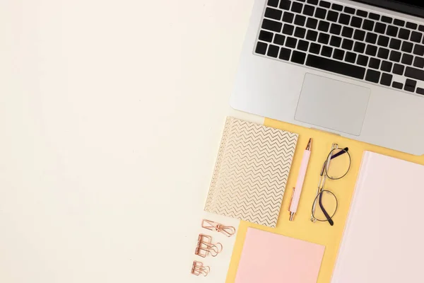 Organized workspace for homeschooling with laptop and office supply on a beige background. E-learning, distance work concept with copy space.