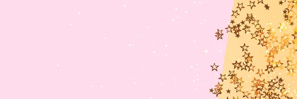 Banner with bright glittering stars confetti scattered on a pink and gold background with copy space.