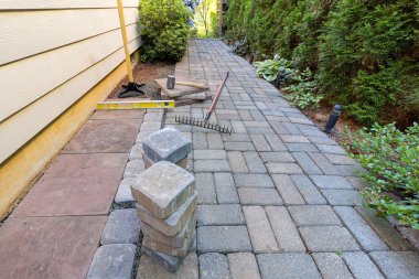 Stone Pavers and Tools for Side Yard Landscaping clipart
