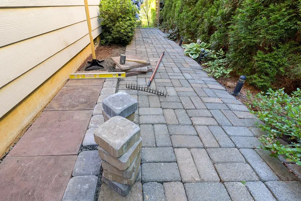 Pavers de pedra e ferramentas para paisagismo jardim lateral — Fotografia de Stock