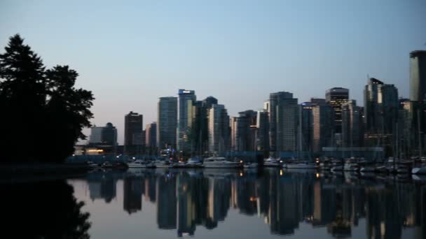 Panning Movie of Downtown City of Vancouver BC Columbia Británica Canadá con condominios Yates Barcos Edificios de oficinas y reflexión sobre el agua Una madrugada del amanecer al amanecer 1080p — Vídeos de Stock