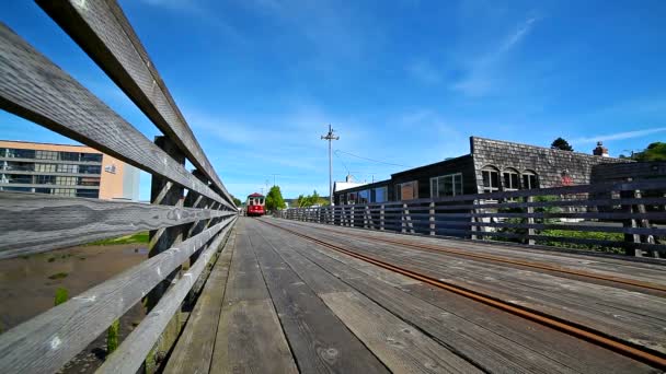 ASTORIA, OREGON - APRIL 27, 2015: Movie of Astoria Trolley going by along the waterfront on boardwalk. Astoria is a coastal town in Oregon Coast popular with tourist. — Stock Video