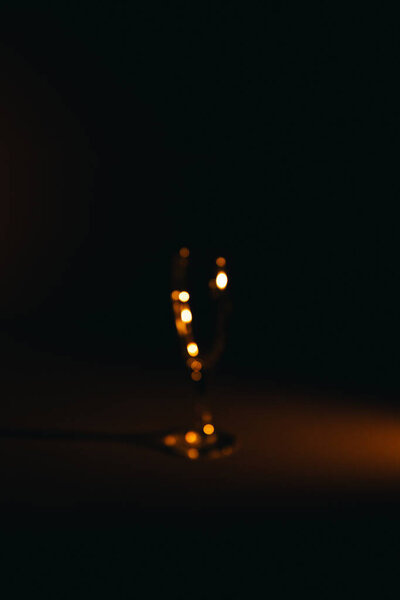 silhouette of a champagne glass on a dark background