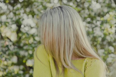 spring photo shoot in nature, beautiful girl walking in the park on a sunny day, close-up details