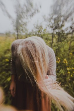 spring photo shoot in nature, beautiful girl walking in the park on a sunny day, close-up details