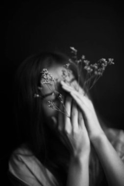 İnsanlar ve kuru bitkiler. Bir kızın minimalist siyah beyaz portresi ve bir bitki. Metin için boşluk