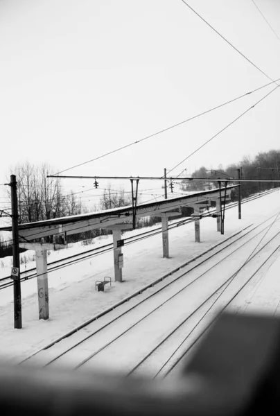 Railway station, rails and road for trains. Urban black and white landscape