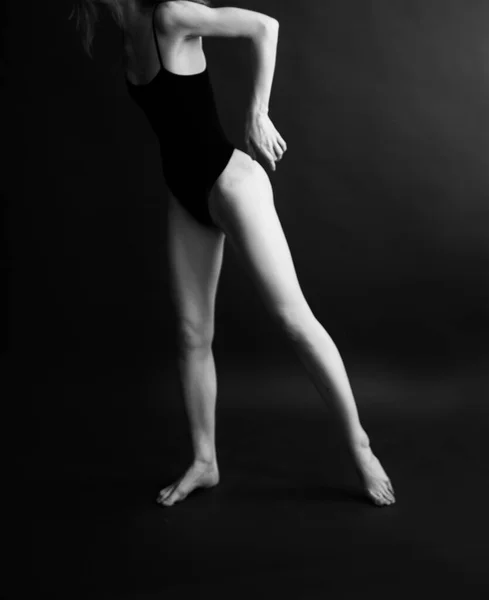 body photography, a dancer in a black bodysuit moves and expresses emotions through dance, black and white fuzzy and blurred film photography