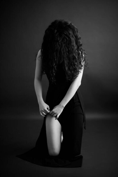 beautiful female legs on dark background isolated