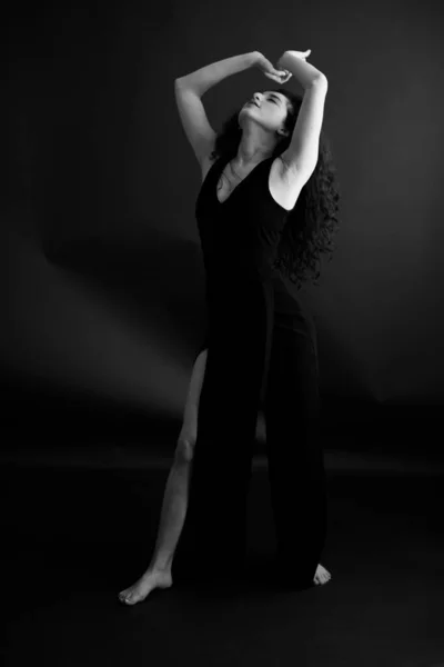 Fashion portrait of a dancer in a black classic dress.
