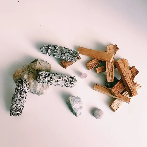 Natural incense White Sage and Palo Santo. Sacred tree of South America, color square photo.White Sage and Palo Santo on white background.