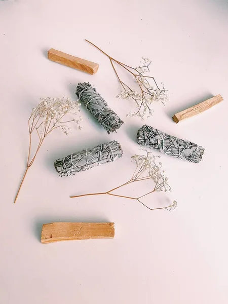 Natural incense White Sage and Palo Santo. Sacred tree of South America, color square photo.White Sage and Palo Santo on white background.
