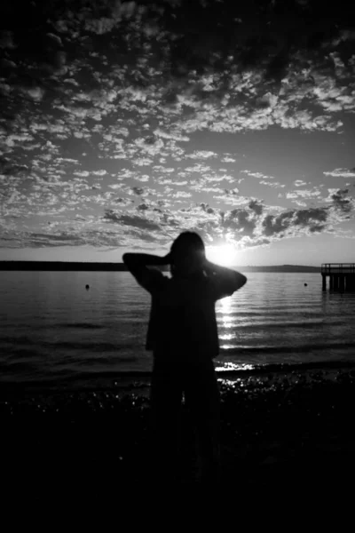 portrait of a woman by the sea, black and white aesthetics, a walk by the ocean. blurred background