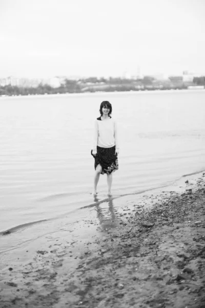 black and white full-length portrait, a girl posing in nature. Art black-and-white frames, fuzzy and noisy, blurring and defocus