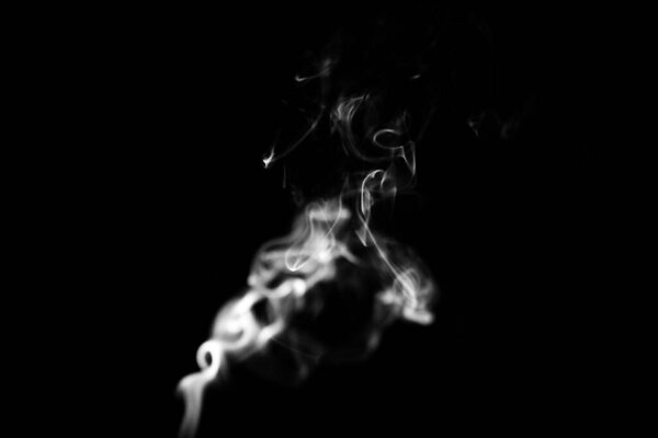Smoke clouds on a black background, white patterns from vape and cigarettes, art photos, soft focus and texture blurring