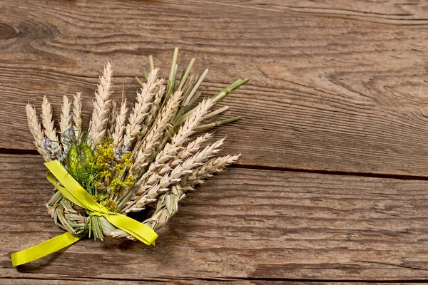 Bundle of wheat with flower and band Stock Picture