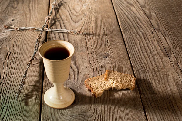 Chalice and bread on the wooden table — Stock Photo, Image