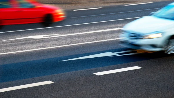 Coches que van a lo largo de la encrucijada al anochecer — Foto de Stock