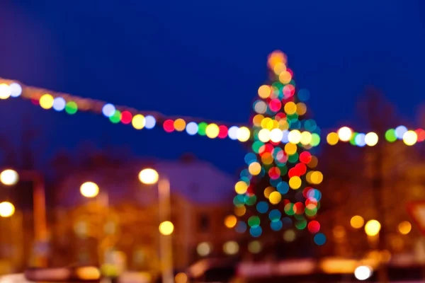 Christmas background with unfocused Christmas tree by night — Stock Photo, Image