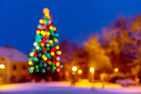 Christmas background with unfocused Christmas tree by night — Stock Photo, Image