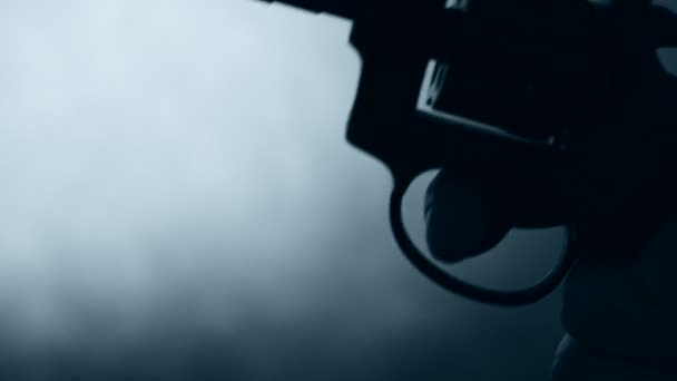 Silhuetten av en mans hand med en pistol — Stockvideo
