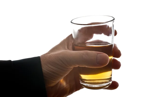 Man behind glass of brandy — Stock Photo, Image