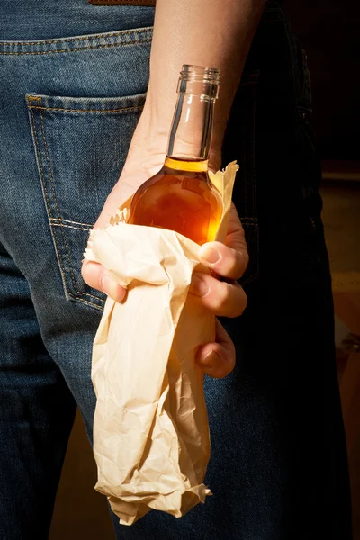 Hard drinker hides a bottle — Stock Photo, Image