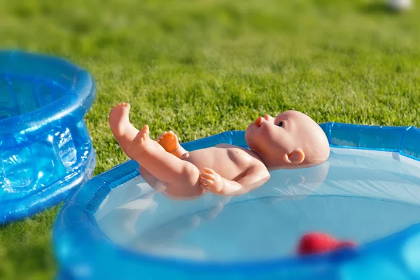 Doll floating in the small pool — Stock Photo, Image